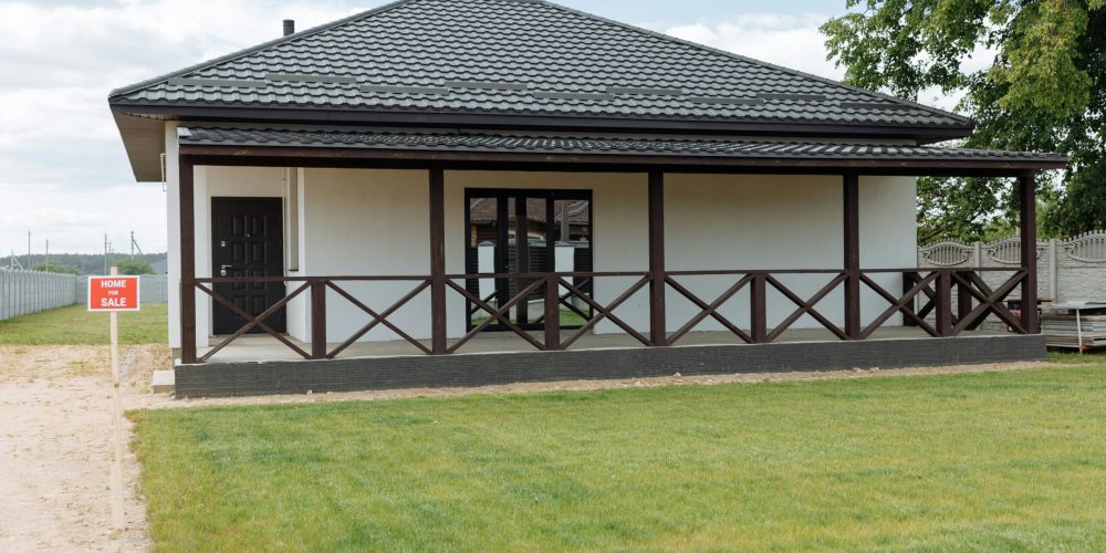 Modern house for sale with a spacious lawn and inviting facade, perfect for families.